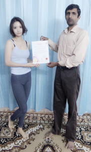 Yoga Instructor/Trainer Young receiving YAI 200 certificate